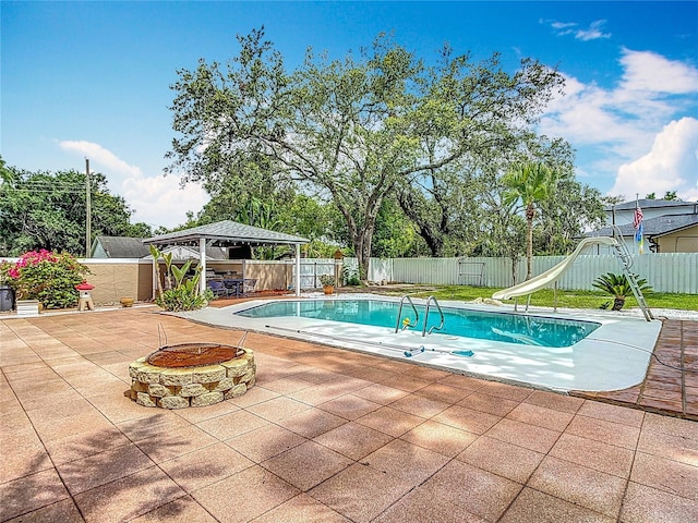 4002 Hudson Ter, Tampa, FL 33618 - view of pool with a gazebo, a water slide, a fire pit, a fenced backyard, and a patio
