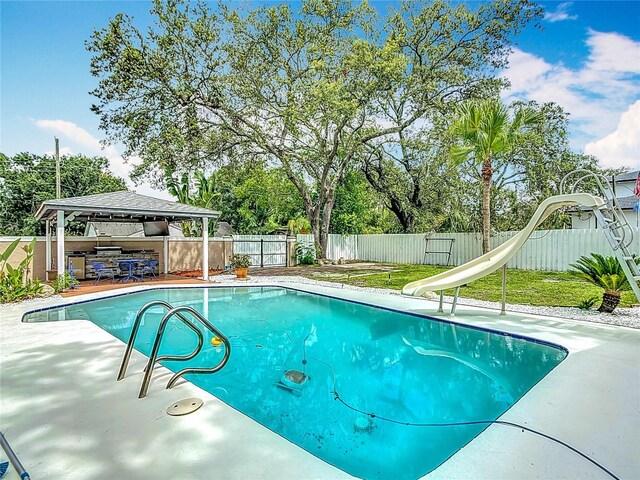 4002 Hudson Ter, Tampa, FL 33618 - view of swimming pool with a gazebo, a water slide, a fenced backyard, and a patio