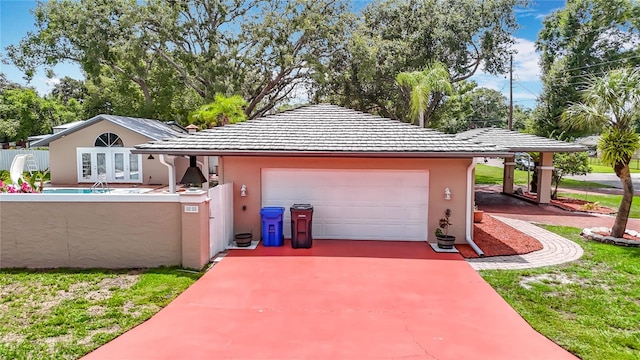 4002 Hudson Ter, Tampa, FL 33618 - garage with french doors and concrete driveway