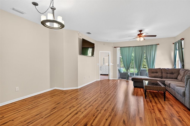 1822 Sassafras Dr, Wesley Chapel, FL 33543 - living room with wood finished floors, a chandelier, and ceiling fan