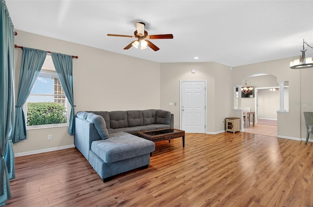 1822 Sassafras Dr, Wesley Chapel, FL 33543 - living room featuring arched walkways, ceiling fan, ornate columns, light wood-style flooring, and recessed lighting
