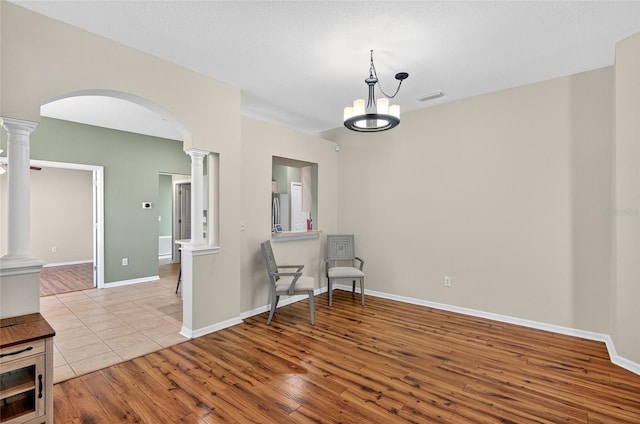 1822 Sassafras Dr, Wesley Chapel, FL 33543 - sitting room featuring ornate columns, arched walkways, and wood finished floors