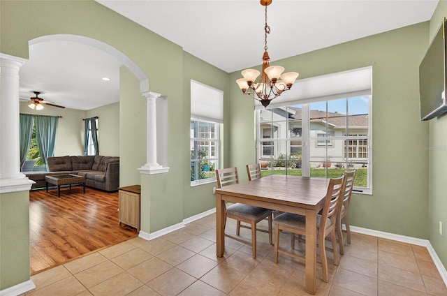 1822 Sassafras Dr, Wesley Chapel, FL 33543 - dining space with decorative columns, arched walkways, and healthy amount of natural light
