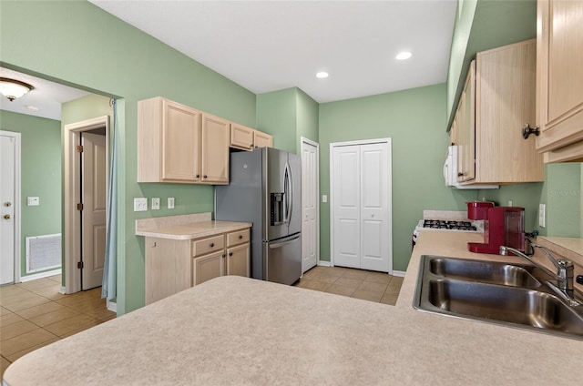 1822 Sassafras Dr, Wesley Chapel, FL 33543 - kitchen featuring white appliances, light brown cabinets, light tile patterned floors, light countertops, and recessed lighting