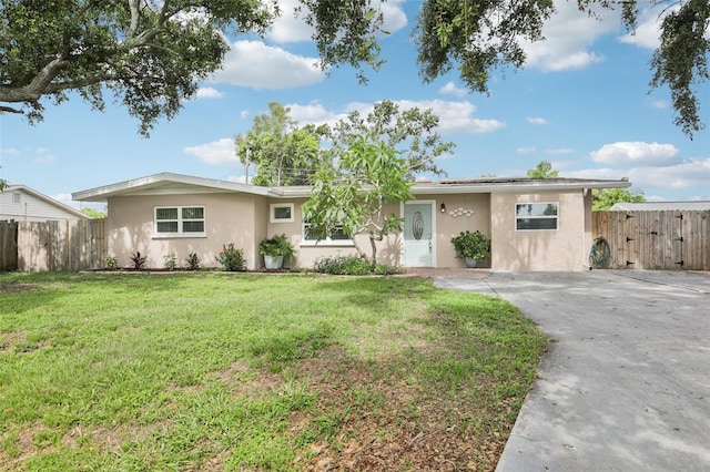 6220 Murdock Ave, Sarasota, FL 34231 - ranch-style house featuring stucco siding, roof mounted solar panels, concrete driveway, and a gate