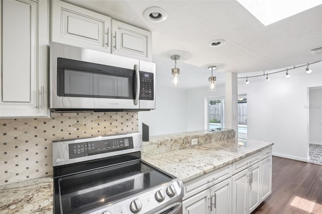 6220 Murdock Ave, Sarasota, FL 34231 - kitchen with stainless steel appliances, decorative backsplash, dark wood finished floors, white cabinets, and light stone counters
