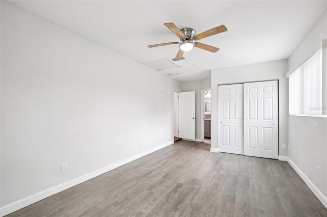 6220 Murdock Ave, Sarasota, FL 34231 - unfurnished bedroom featuring multiple windows, wood finished floors, a closet, and ceiling fan