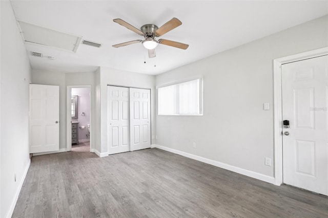 6220 Murdock Ave, Sarasota, FL 34231 - unfurnished bedroom featuring wood finished floors, a closet, ensuite bath, and a ceiling fan