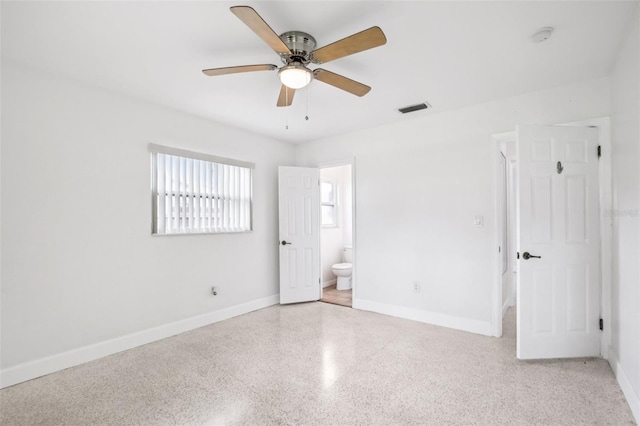 6220 Murdock Ave, Sarasota, FL 34231 - unfurnished bedroom with dark aggregate flooring, ensuite bathroom, and a ceiling fan