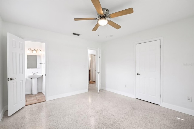 6220 Murdock Ave, Sarasota, FL 34231 - unfurnished bedroom with speckled floor, ensuite bathroom, and ceiling fan