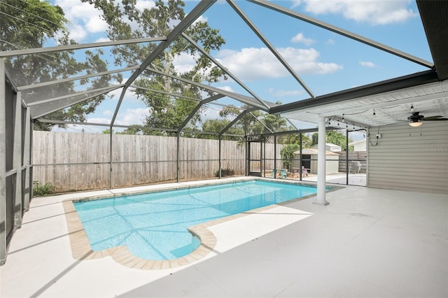6220 Murdock Ave, Sarasota, FL 34231 - view of swimming pool with a patio, a storage shed, a fenced backyard, glass enclosure, and a ceiling fan
