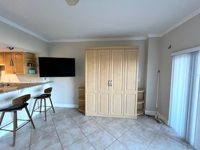 880 Mandalay Ave Unit C412, Clearwater Beach, FL 33767 - kitchen featuring open shelves, ornamental molding, light brown cabinets, a breakfast bar area, and light tile patterned floors