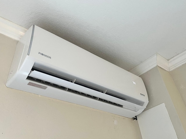 880 Mandalay Ave Unit C412, Clearwater Beach, FL 33767 - detailed view of a wall mounted air conditioner and a textured ceiling