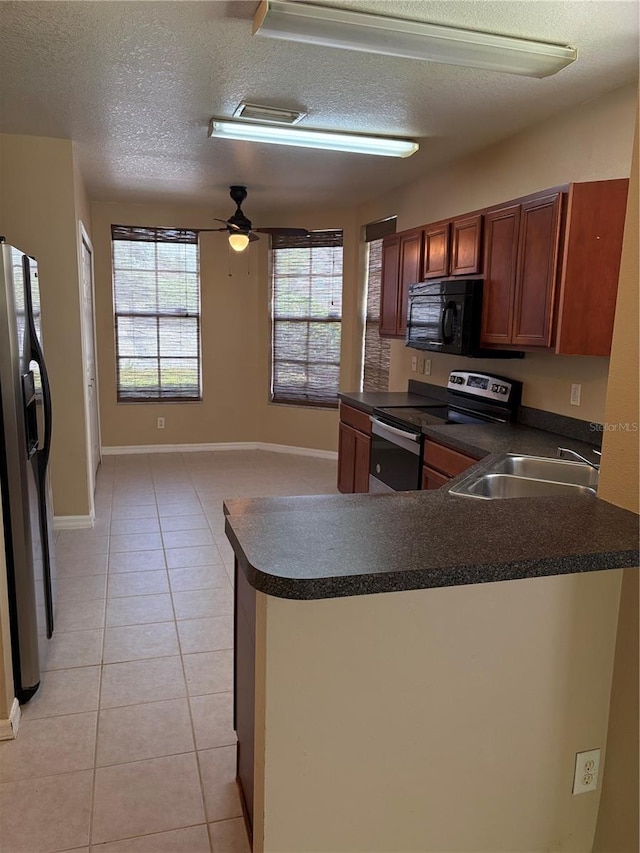 6252 Olivedale Dr, Riverview, FL 33578 - kitchen with electric range, refrigerator with ice dispenser, dark countertops, black microwave, and a peninsula