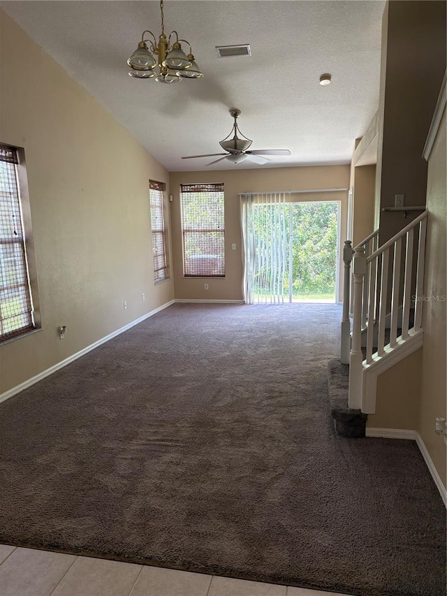 6252 Olivedale Dr, Riverview, FL 33578 - carpeted empty room featuring plenty of natural light, a ceiling fan, a chandelier, stairs, and vaulted ceiling