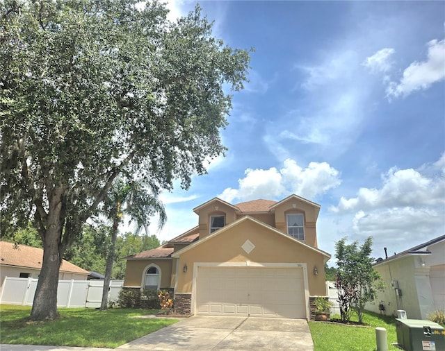 31141 Harthorn Ct, Wesley Chapel, FL 33543 - mediterranean / spanish home with stucco siding, stone siding, driveway, and a garage