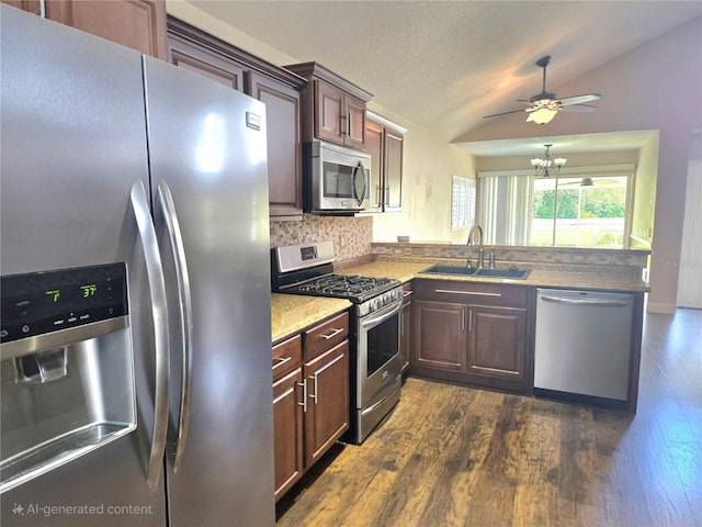 31141 Harthorn Ct, Wesley Chapel, FL 33543 - kitchen with stainless steel appliances, lofted ceiling, backsplash, a peninsula, and dark wood-style flooring