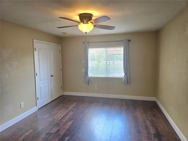 31141 Harthorn Ct, Wesley Chapel, FL 33543 - unfurnished bedroom featuring dark wood-type flooring, a textured ceiling, a ceiling fan, and a closet