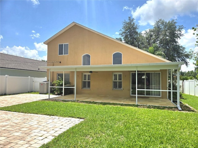 31141 Harthorn Ct, Wesley Chapel, FL 33543 - back of property featuring a patio area, ceiling fan, a fenced backyard, and stucco siding