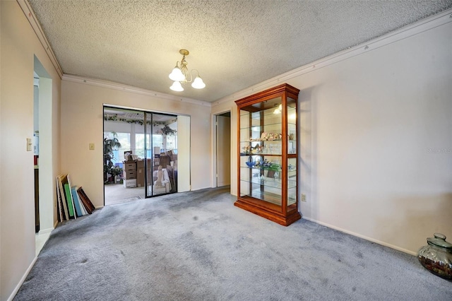 2817 Rustic Oaks Dr, Palm Harbor, FL 34684 - carpeted spare room featuring a chandelier, crown molding, and a textured ceiling