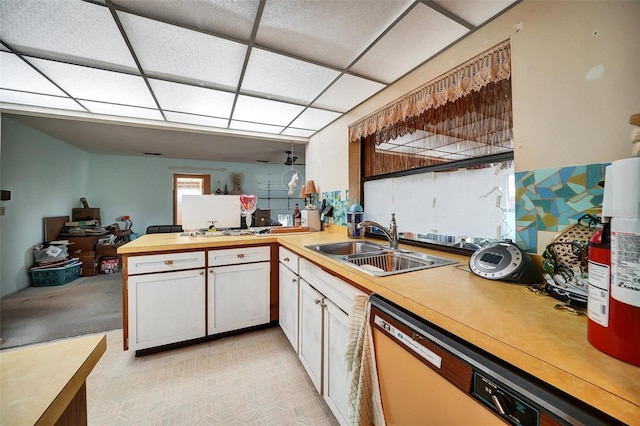2817 Rustic Oaks Dr, Palm Harbor, FL 34684 - kitchen with dishwashing machine, a peninsula, a paneled ceiling, and white cabinetry