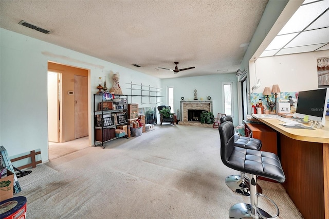 2817 Rustic Oaks Dr, Palm Harbor, FL 34684 - office space featuring carpet, a ceiling fan, a fireplace with raised hearth, and a textured ceiling