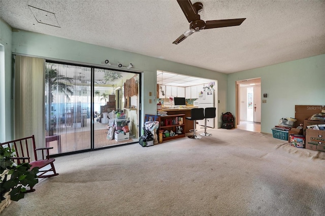 2817 Rustic Oaks Dr, Palm Harbor, FL 34684 - sitting room featuring carpet flooring, ceiling fan, and a textured ceiling