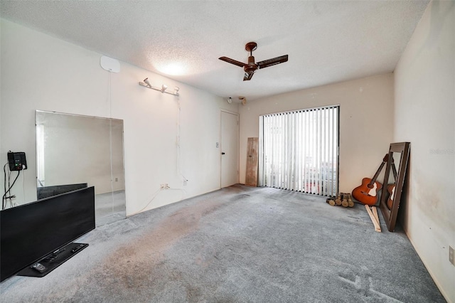 2817 Rustic Oaks Dr, Palm Harbor, FL 34684 - unfurnished living room featuring a ceiling fan, carpet, and a textured ceiling