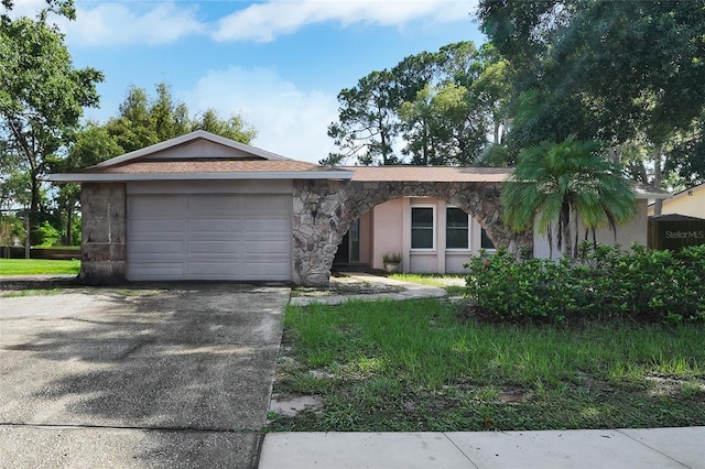 2817 Rustic Oaks Dr, Palm Harbor, FL 34684 - ranch-style home featuring stone siding, concrete driveway, and a garage