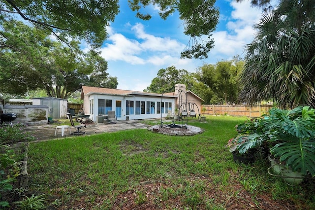 2817 Rustic Oaks Dr, Palm Harbor, FL 34684 - rear view of property with a storage unit, a patio, and stucco siding