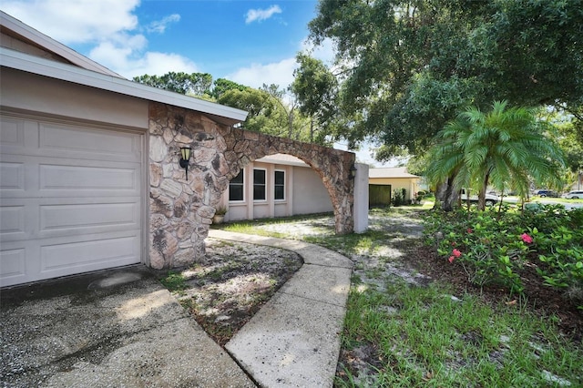 2817 Rustic Oaks Dr, Palm Harbor, FL 34684 - view of yard with a garage and concrete driveway