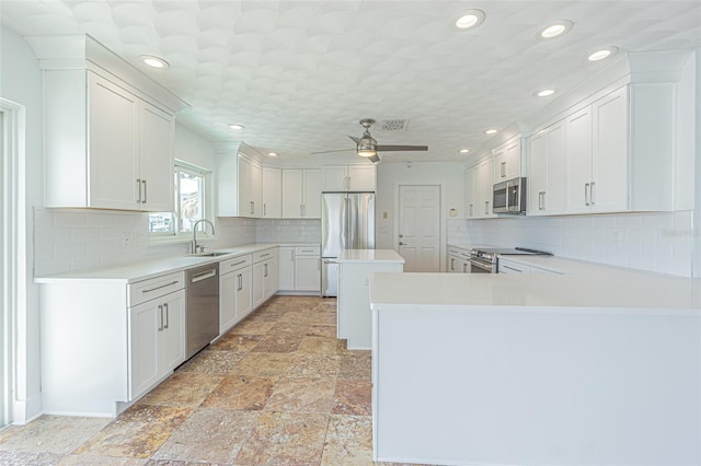 5950 Bikini Way N, St Pete Beach, FL 33706 - kitchen with appliances with stainless steel finishes, light countertops, backsplash, a ceiling fan, and recessed lighting