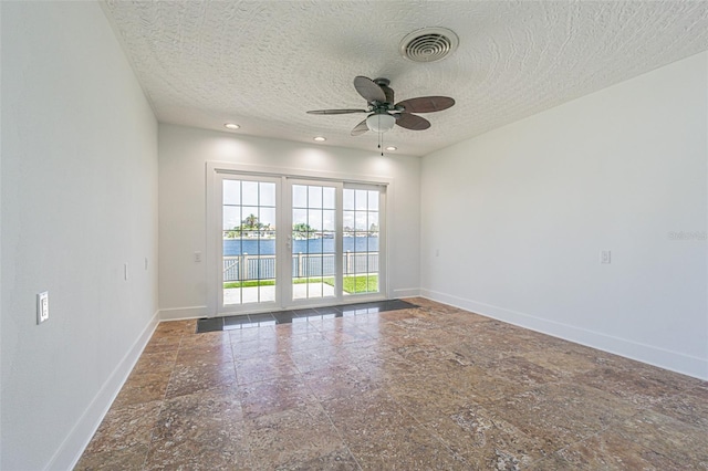5950 Bikini Way N, St Pete Beach, FL 33706 - spare room with ceiling fan, a textured ceiling, and recessed lighting