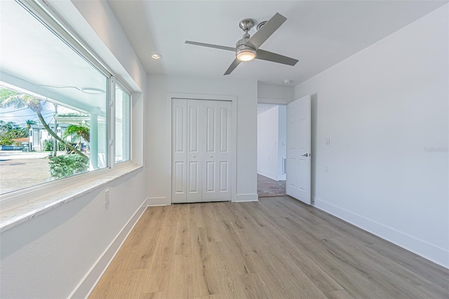 5950 Bikini Way N, St Pete Beach, FL 33706 - unfurnished bedroom with light wood finished floors, a closet, a ceiling fan, and recessed lighting