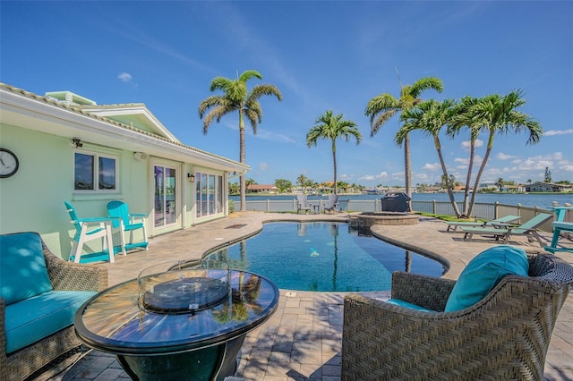 5950 Bikini Way N, St Pete Beach, FL 33706 - view of swimming pool with a patio area, a fenced backyard, a pool with connected hot tub, and french doors