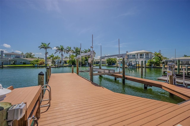 5950 Bikini Way N, St Pete Beach, FL 33706 - dock area featuring boat lift, a water view, and a residential view