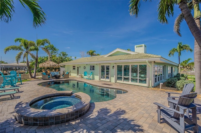 5950 Bikini Way N, St Pete Beach, FL 33706 - view of swimming pool with a patio area and a pool with connected hot tub