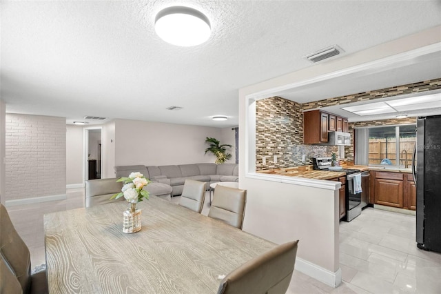 6715 Ranchwood Loop, New Port Richey, FL 34653 - dining space with a textured ceiling and baseboards