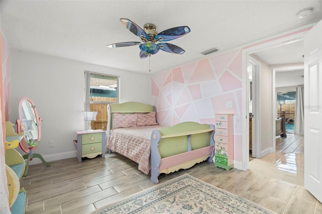 6715 Ranchwood Loop, New Port Richey, FL 34653 - bedroom featuring wood tiled floors and a ceiling fan