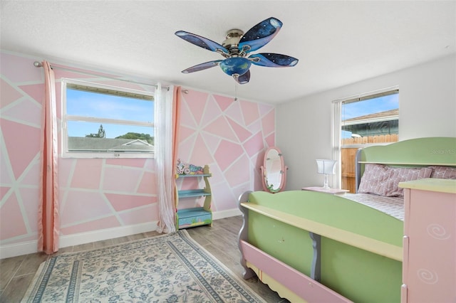 6715 Ranchwood Loop, New Port Richey, FL 34653 - bedroom featuring wood finished floors and baseboards
