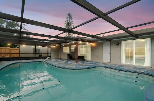 6715 Ranchwood Loop, New Port Richey, FL 34653 - pool at dusk featuring a patio area and a lanai