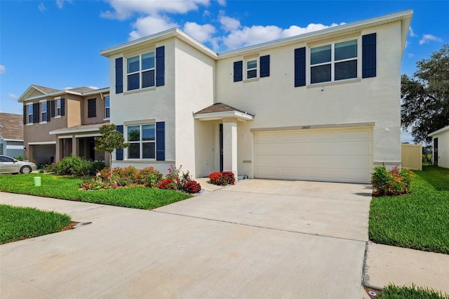 33657 Field Maple Loop, Wesley Chapel, FL 33545 - view of front facade with stucco siding, an attached garage, and concrete driveway