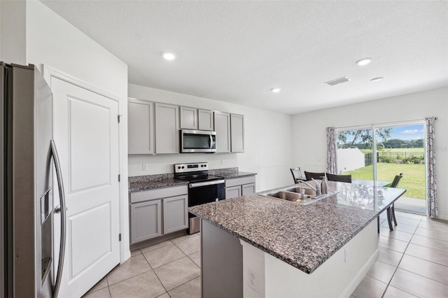 33657 Field Maple Loop, Wesley Chapel, FL 33545 - kitchen featuring appliances with stainless steel finishes, gray cabinetry, light tile patterned floors, and recessed lighting