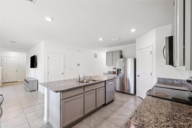 33657 Field Maple Loop, Wesley Chapel, FL 33545 - kitchen featuring stainless steel appliances, gray cabinetry, light tile patterned floors, a kitchen island with sink, and recessed lighting