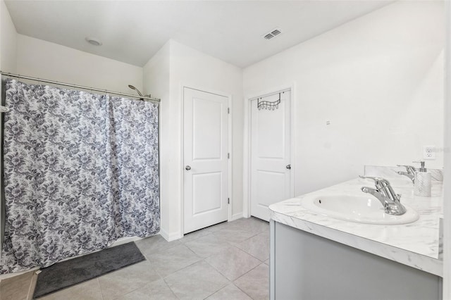 33657 Field Maple Loop, Wesley Chapel, FL 33545 - full bathroom featuring double vanity, tile patterned floors, and curtained shower