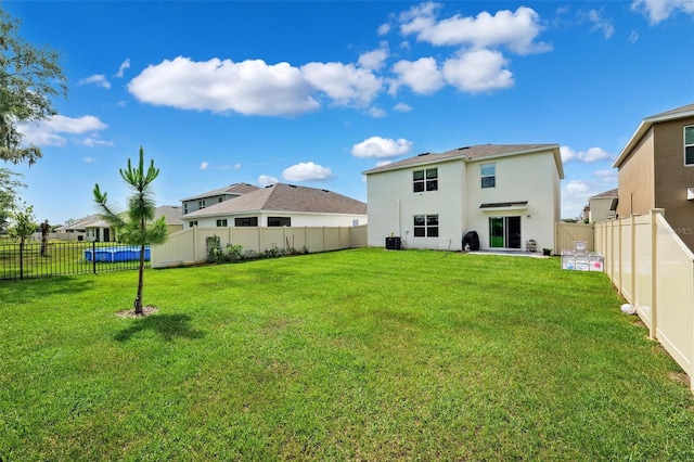 33657 Field Maple Loop, Wesley Chapel, FL 33545 - back of property featuring a fenced backyard and stucco siding
