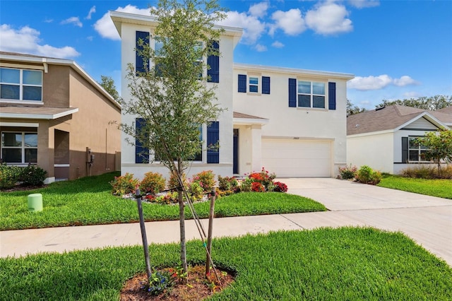 33657 Field Maple Loop, Wesley Chapel, FL 33545 - view of front of property featuring stucco siding, an attached garage, driveway, and a front yard