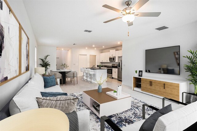 6347 Ten Acre Ct, Zephyrhills, FL 33541 - living area featuring light tile patterned floors, a ceiling fan, and recessed lighting
