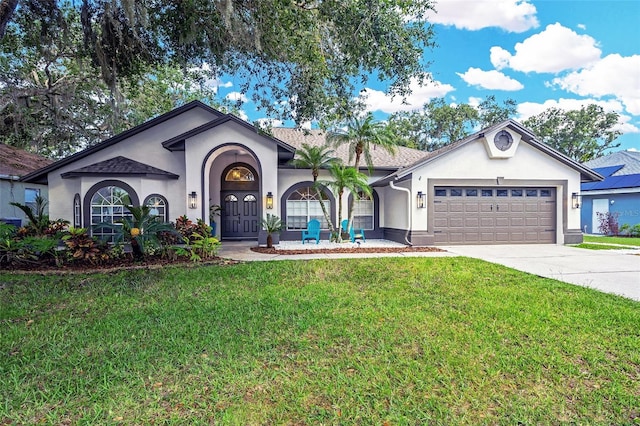 4617 Basswood St, Land O Lakes, FL 34639 - view of front of house featuring stucco siding, an attached garage, concrete driveway, and a front lawn