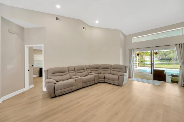4617 Basswood St, Land O Lakes, FL 34639 - living room featuring high vaulted ceiling, light wood-style flooring, and recessed lighting